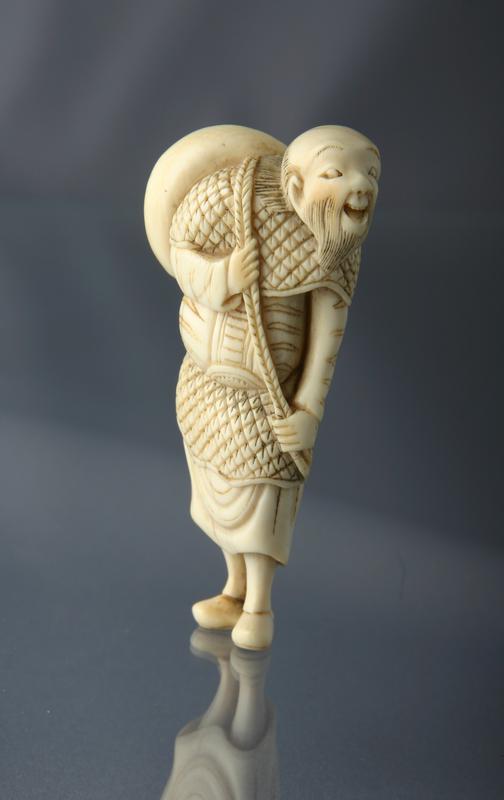 Netsuke of a Daoist Sennin with Hat Slung over his Shoulder