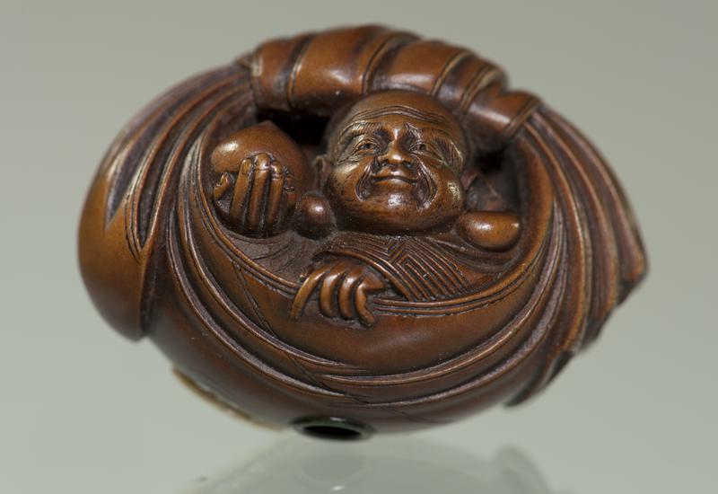 Netsuke of Hotei Seated in his Bag