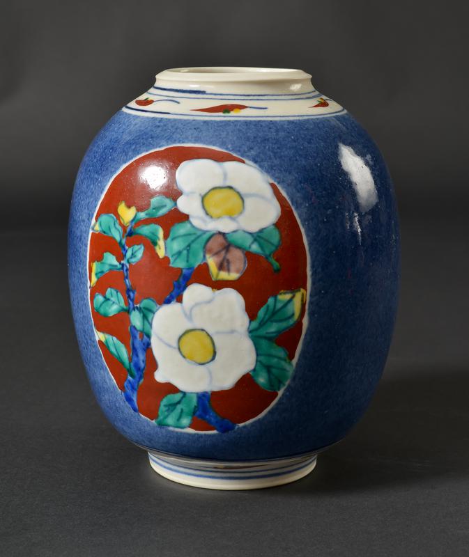 Vase with blue glaze and painted floral decoration