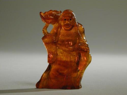 Small Amber Carving of a Female Immortal with Inlaid Eyes