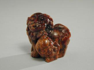 Amber Carving of a Buddhistic Lion and Pup