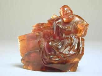 Amber Figurine of an Immortal (Li tie Quai) amidst Boxes