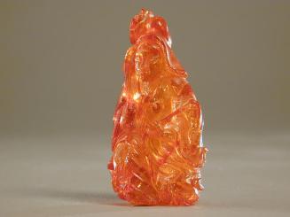Amber Figurine of a Seated Deity with a Whisk and Lotus