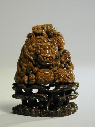 Amber carving of Buddhist Lions