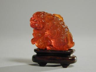 Amber Carving of a Buddhistic Lion and Ball