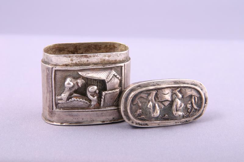 Silver Opium Box with Relief Designs of figures near a building and figures playing chess