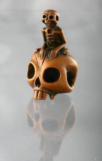Netsuke of A Skeleton on a Skull