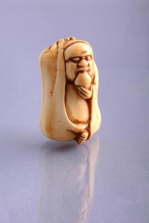 Netsuke: Ivory Figure of a Daruma with a Peach