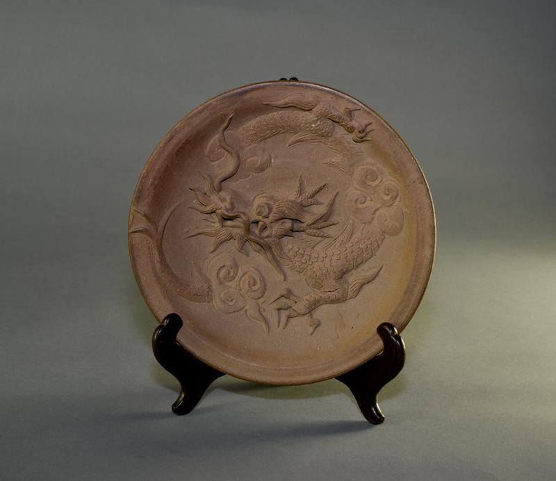 Unglazed plate with dragon