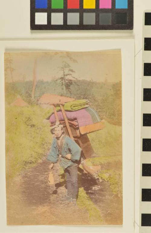 Untitled (Man carrying household goods, moving)