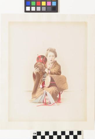 untitled (young lady playing the Tzuszumi hand drum)