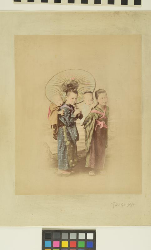 Untitled (Two young girls under an umbrella with babies on their backs)