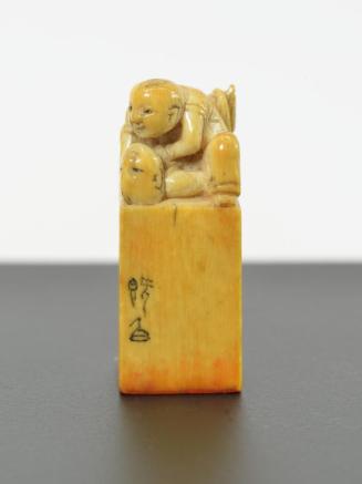 Ivory Seal with Two Boys Wrestling Design