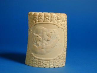 Carved Ivory Tusk with Lion family surrounded by masks and heads