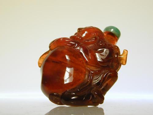 Amber Snuff Bottle in the Form of Budai Resting his Hands on his Sack