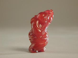 Amber Figurine of a Boy with Lotus