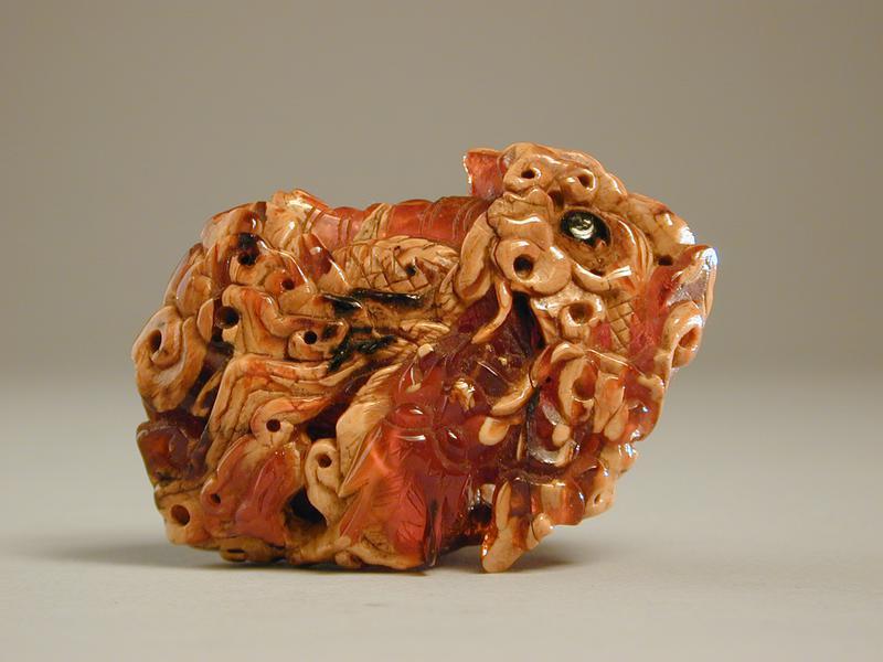 Amber Figurine of a Dragon chasing a Pearl