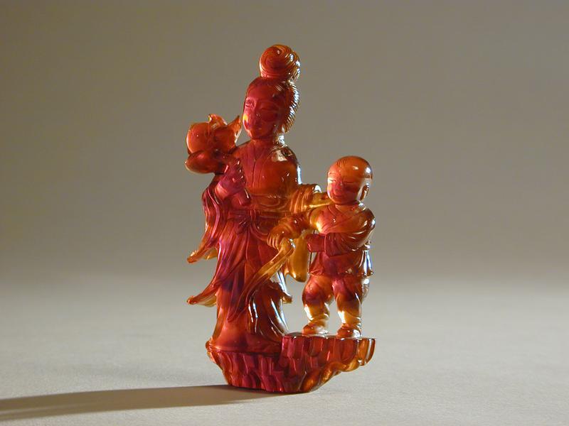 Amber Carving of Female Immortal with Lotus and Child