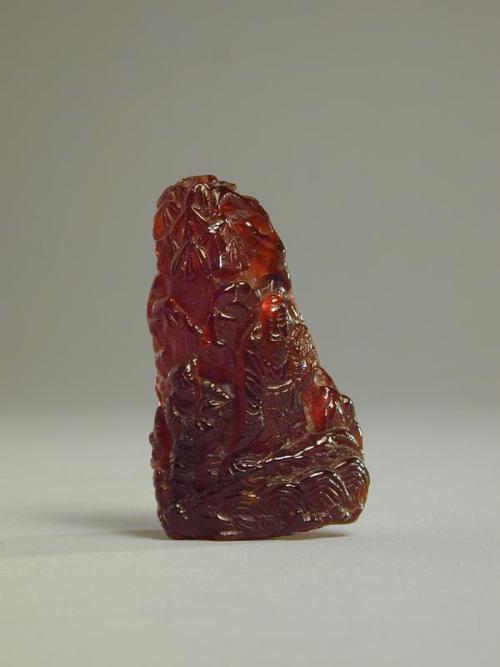 Small Amber Carving of a Mountain with Figures