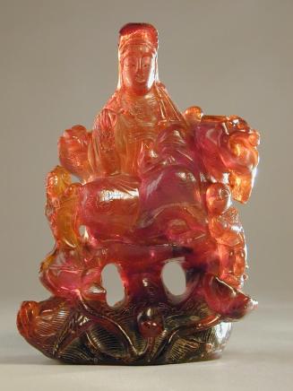 Amber Carving of Guanyin Seated on a Rock